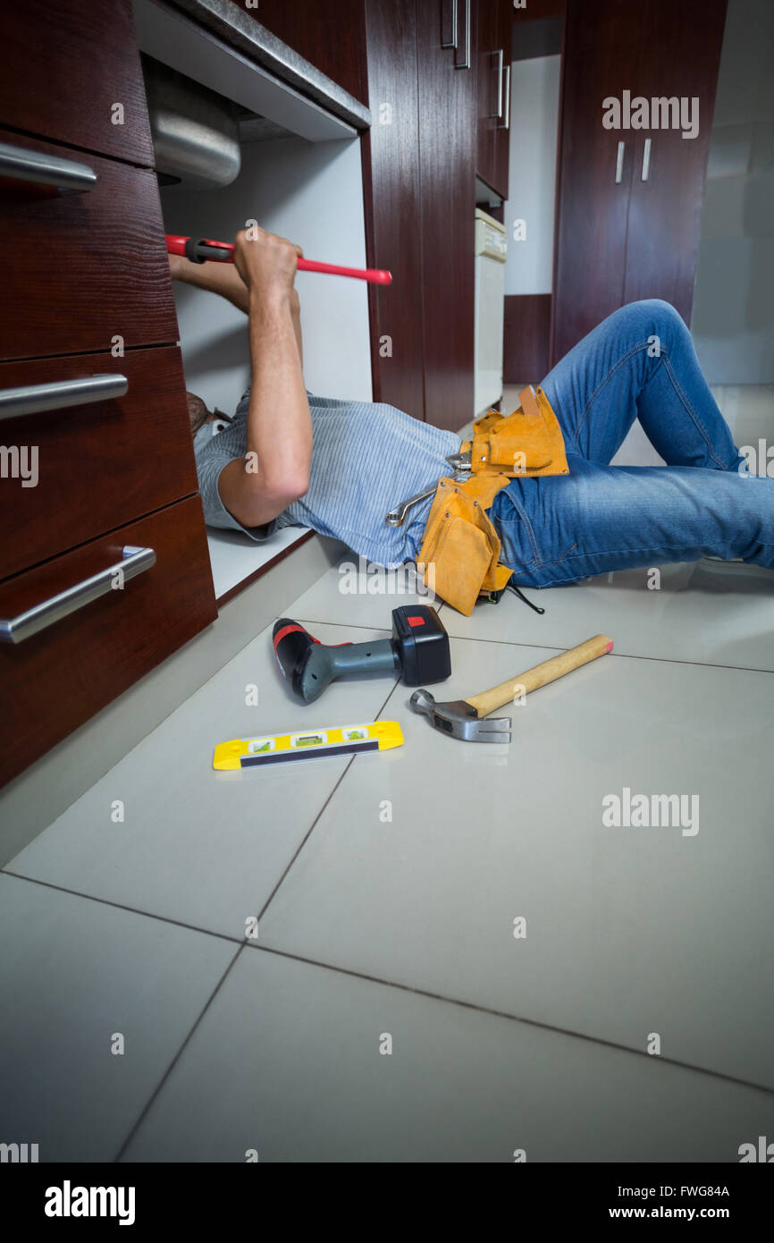 Midsection of man using pipe wrench Stock Photo Alamy