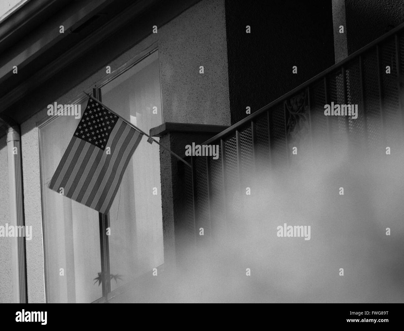 A Small USA Flag Sticking out of a Balcony Stock Photo