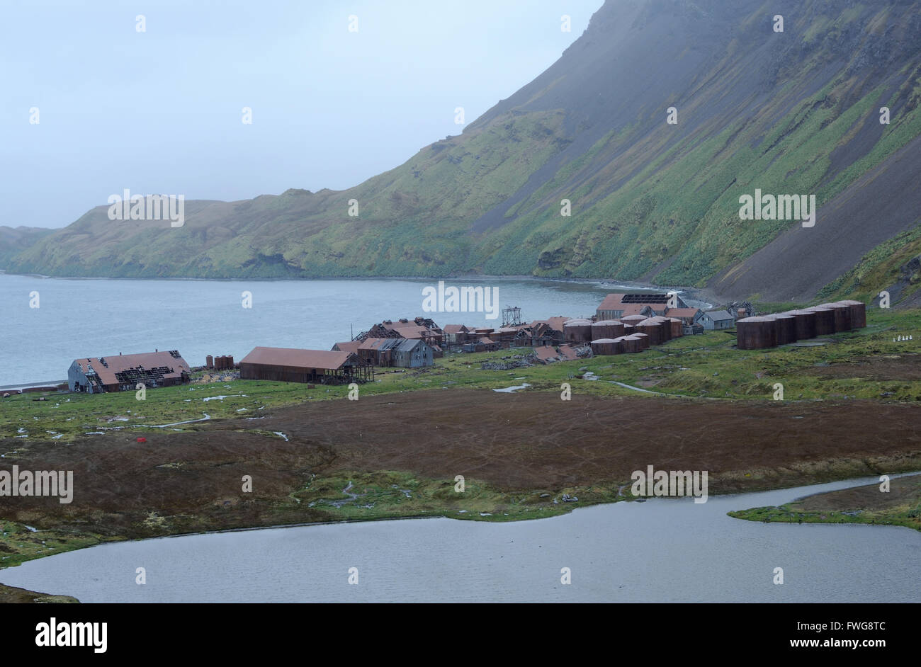 The ruined abandoned whaling station in Stromness and Stromness Bay.  Stromness, Stromness Bay, South Georgia, South Atlantic. Stock Photo