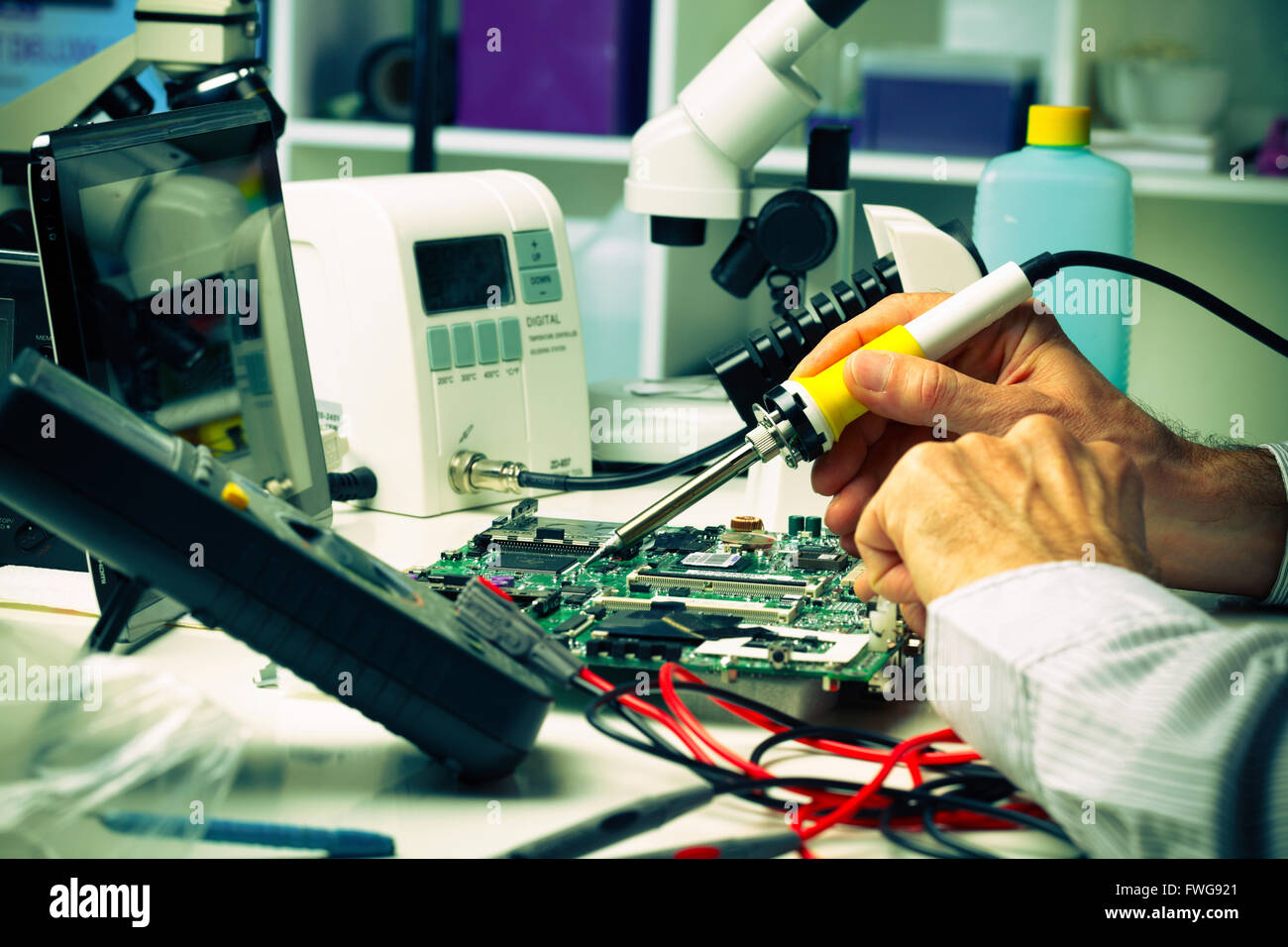 Soldering a micro chip onto a printed circuit board Stock Photo Alamy