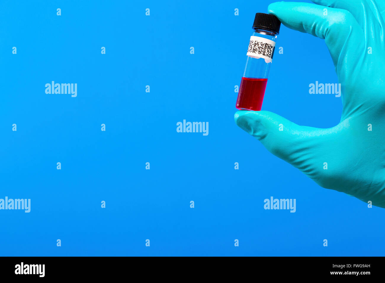 Person holding virology test tube. Stock Photo