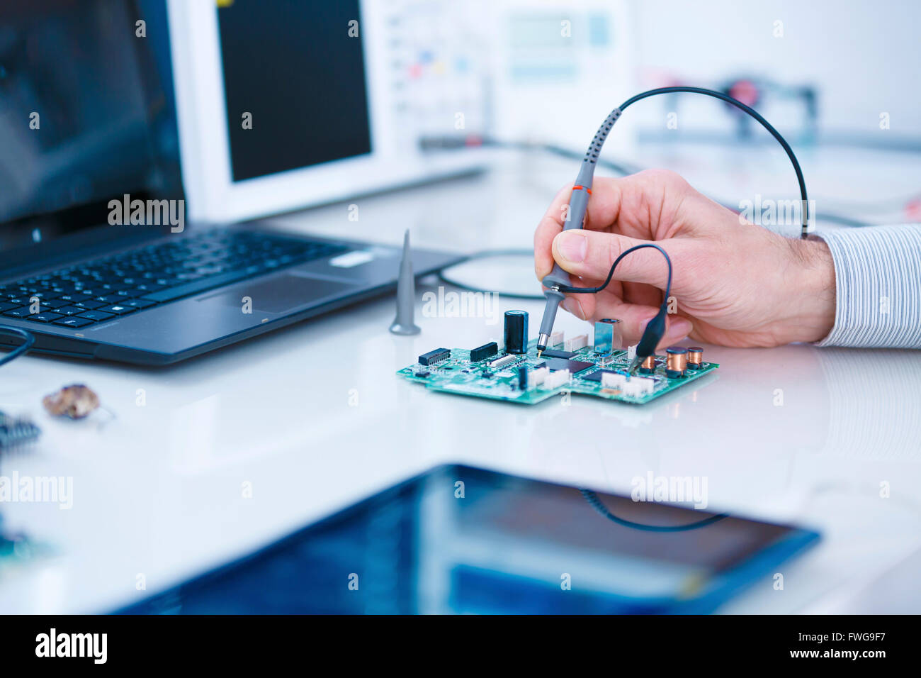 Person adjusting microprocessor in a laboratory Stock Photo - Alamy