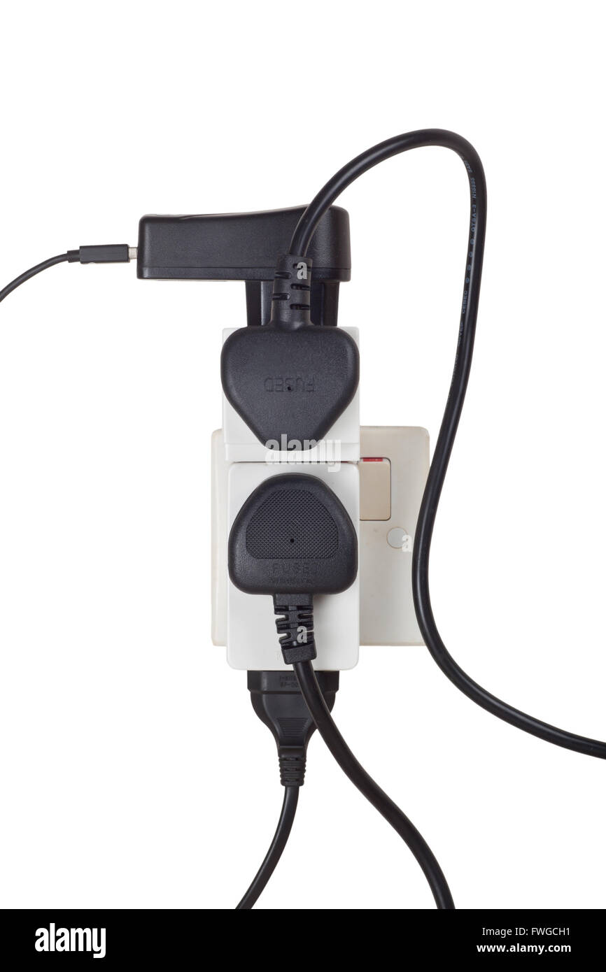 Many power cables plug into a power socket isolated on white background Stock Photo