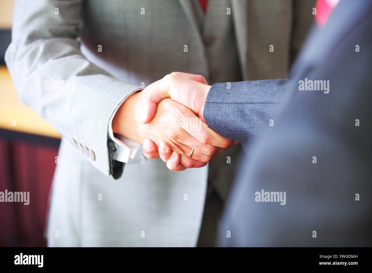 UK Business men in the city shake hands to seal the contract Stock Photo