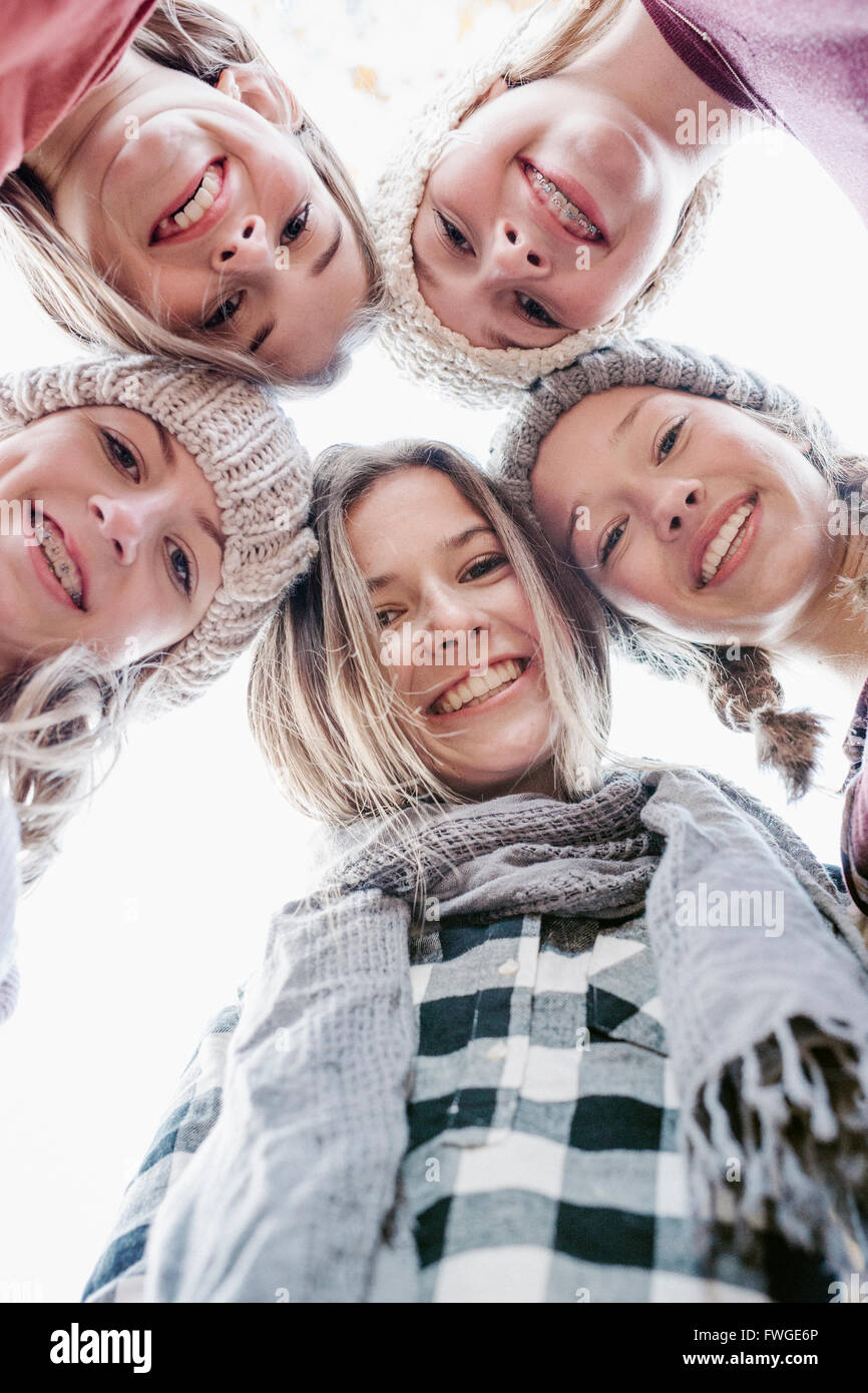 A group of five teenage girls outdoors in woolly hats and scarves. Stock Photo
