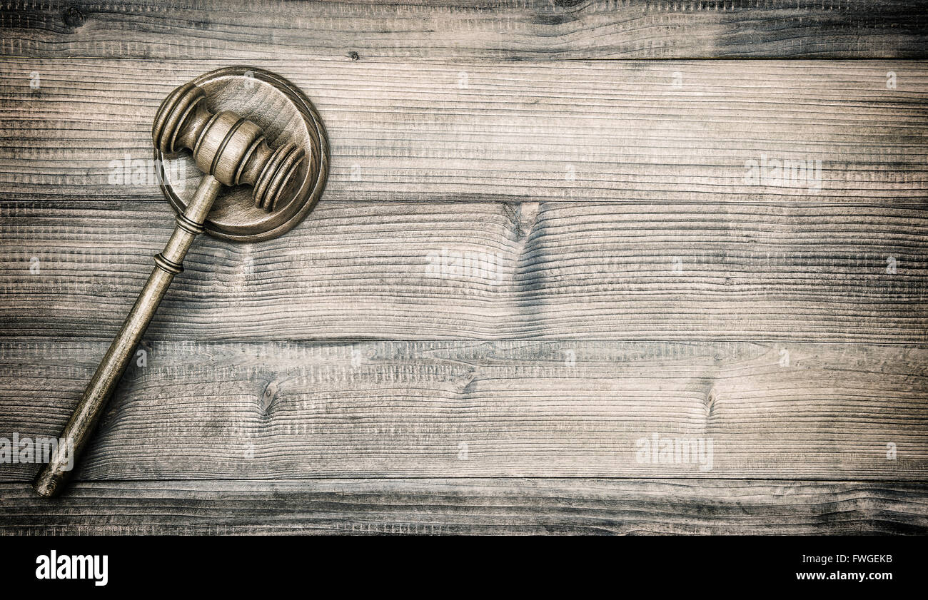 Judges Gavel with Soundboard. Auctioneer hammer on wooden background. VIntage style toned picture Stock Photo
