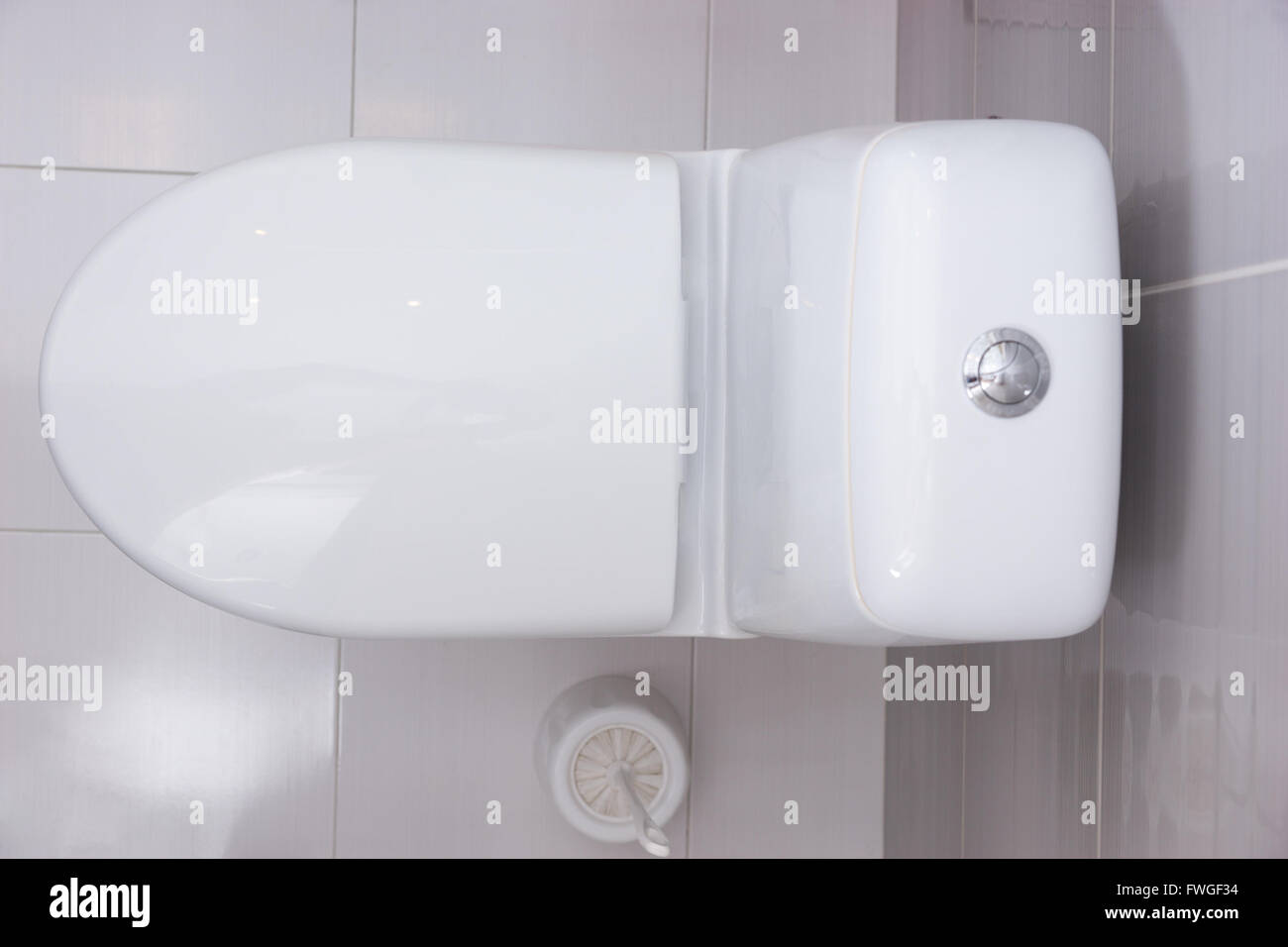 Close up overhead view of a plain white toilet with the seat shut and