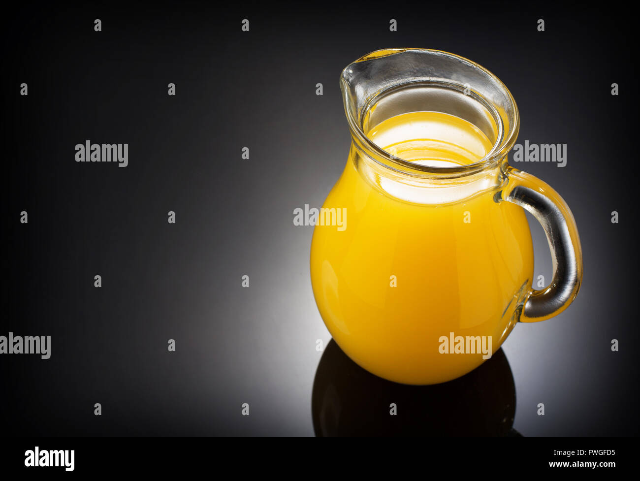 Glass jug with orange juice Stock Photo - Alamy