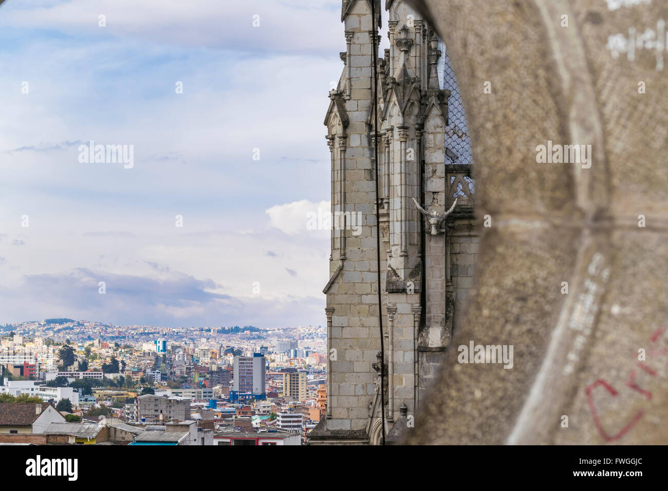 Detail view from one of his windows of neo gothic style San Juan Basilica and cityscape at historic center of Quito, Ecuador Stock Photo