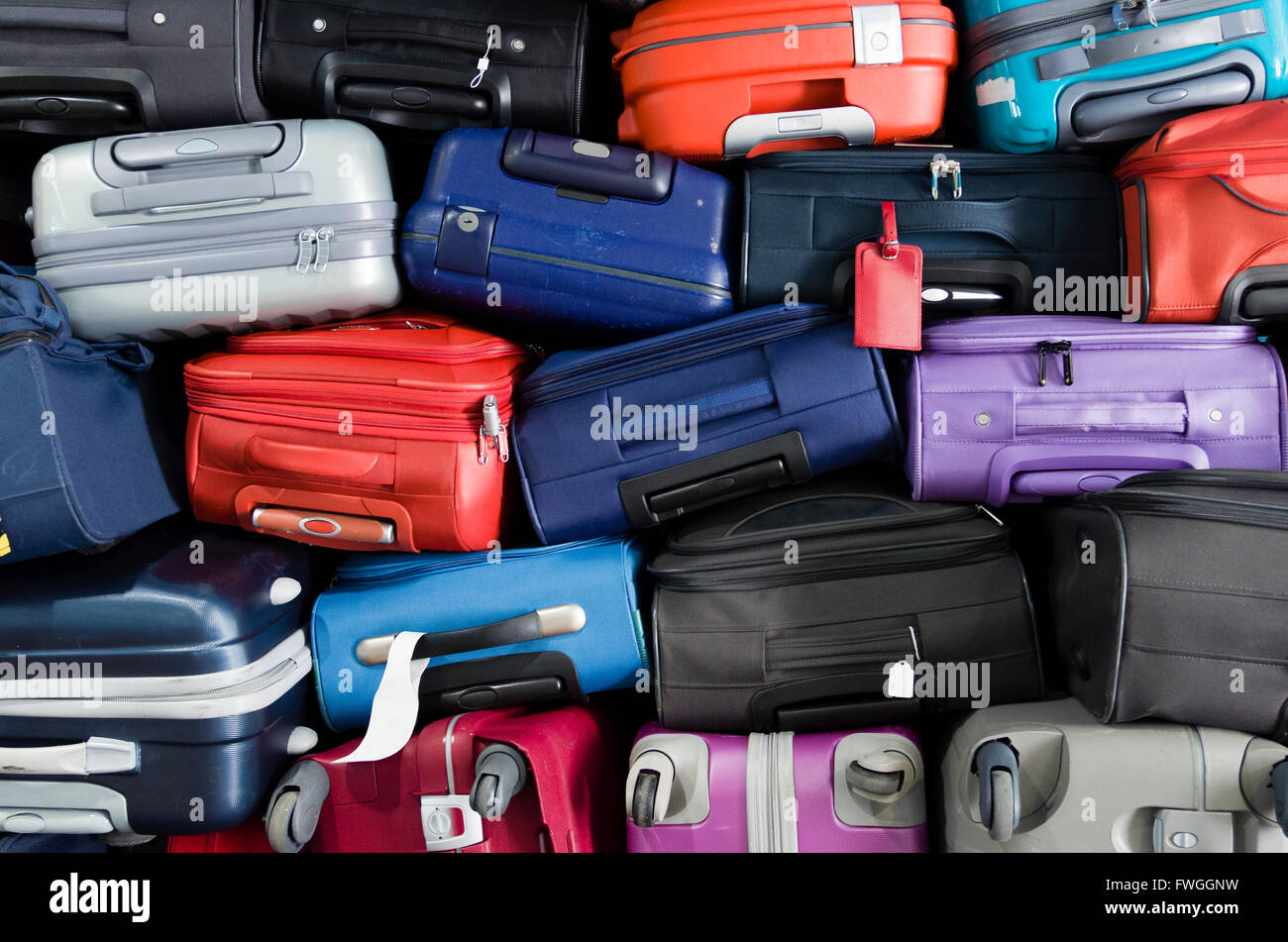 Suitcases multicolor stacked for transport one above the other Stock Photo