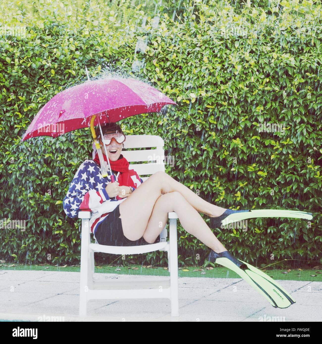 Woman holding umbrella in rain Stock Photo Alamy