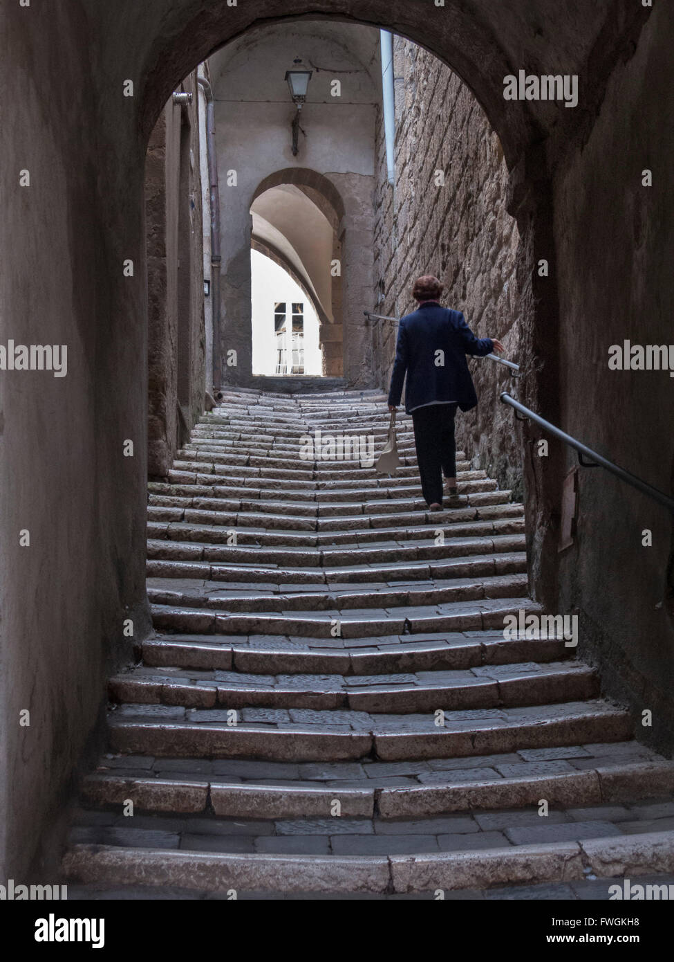 Woman Moving Up Steps Stock Photo