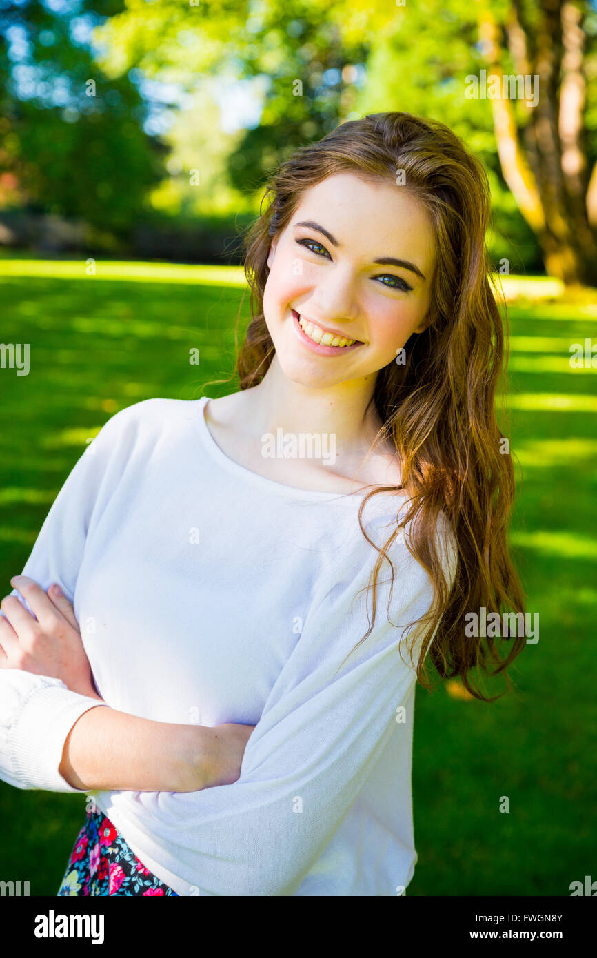 a beautiful young girl poses for a fashion style portrait outdoors FWGN8Y