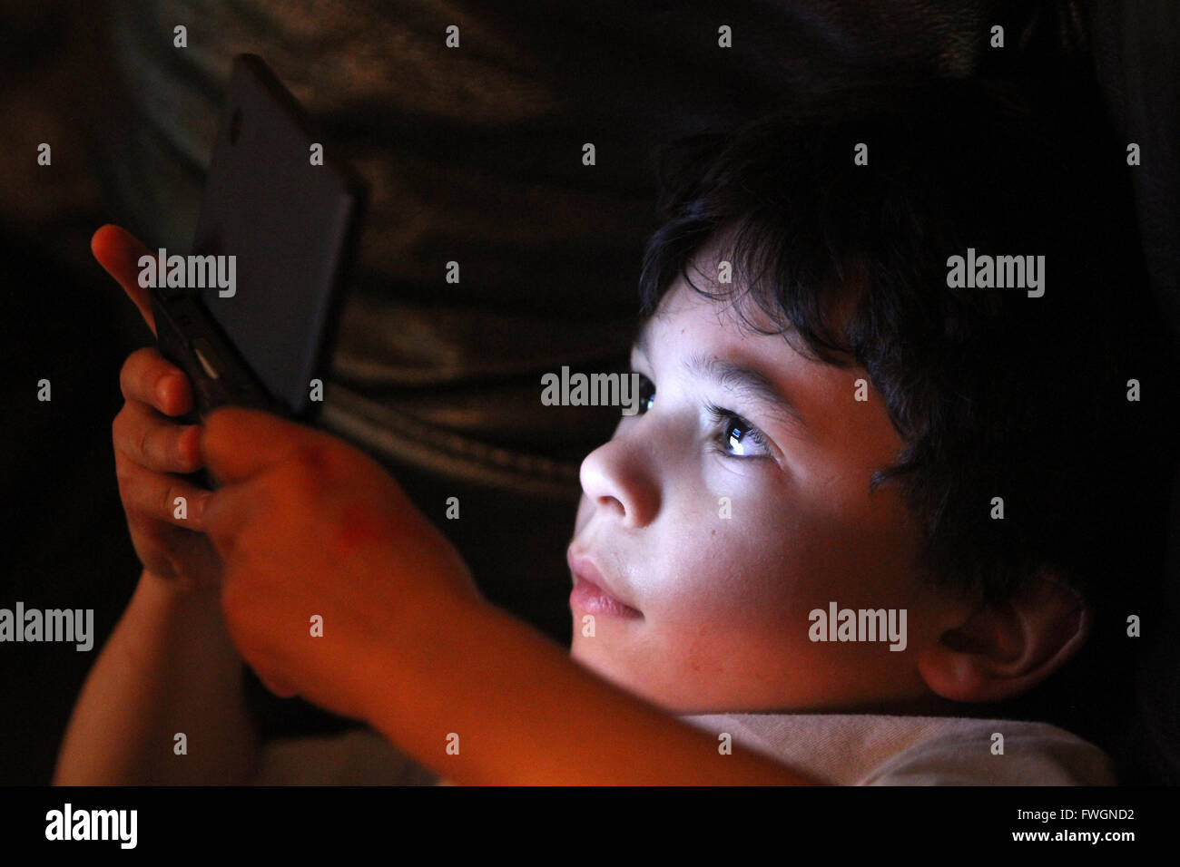 Young boy playing computer console Stock Photo