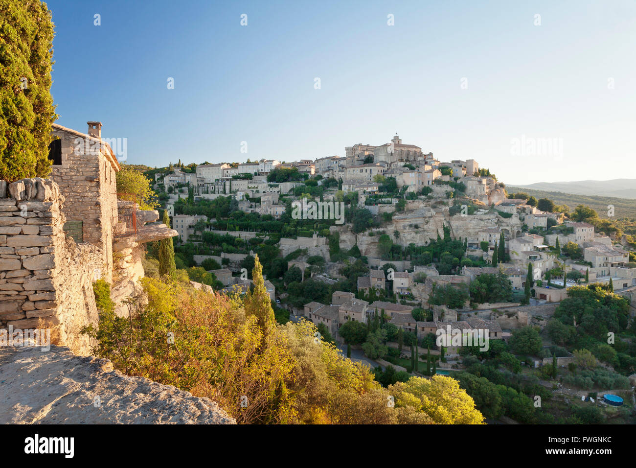 Hilltop village of Gordes with castle and church at sunrise, Provence, Provence-Alpes-Cote d'Azur, France, Europe Stock Photo