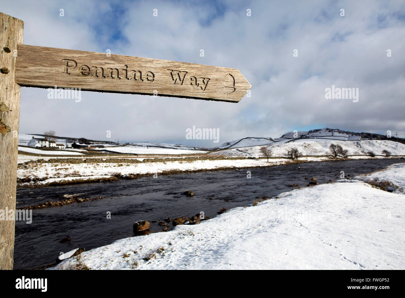 Sign for the Pennine Way walking trail on snowy landscape by the River Tees, Upper Teesdale, County Durham, England Stock Photo