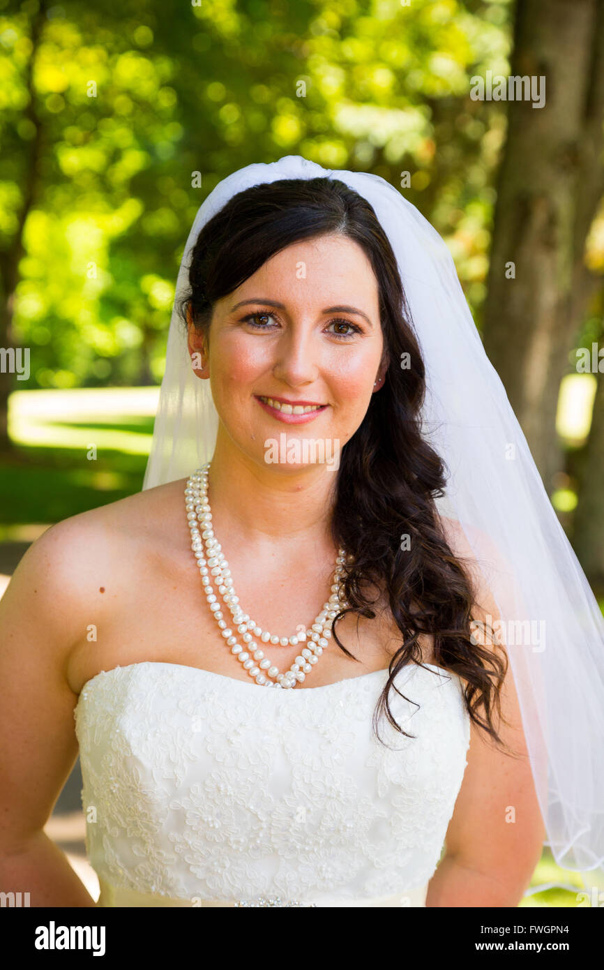 A Bride Poses For Some Portraits While Wearing Her Wedding Dress