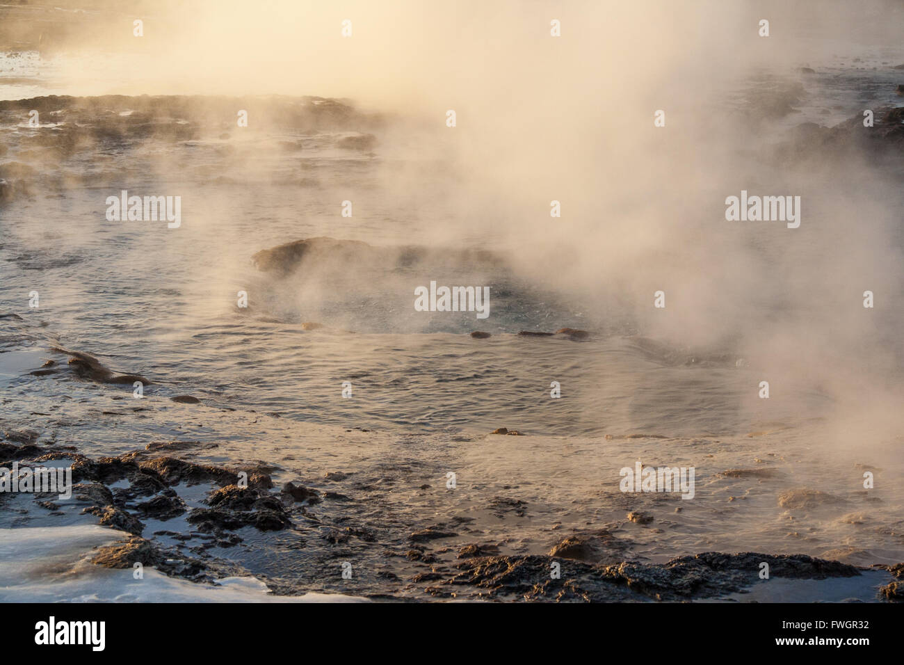 Steam from Strokkur geysir, ice in the foreground, Golden Circle, Iceland Stock Photo