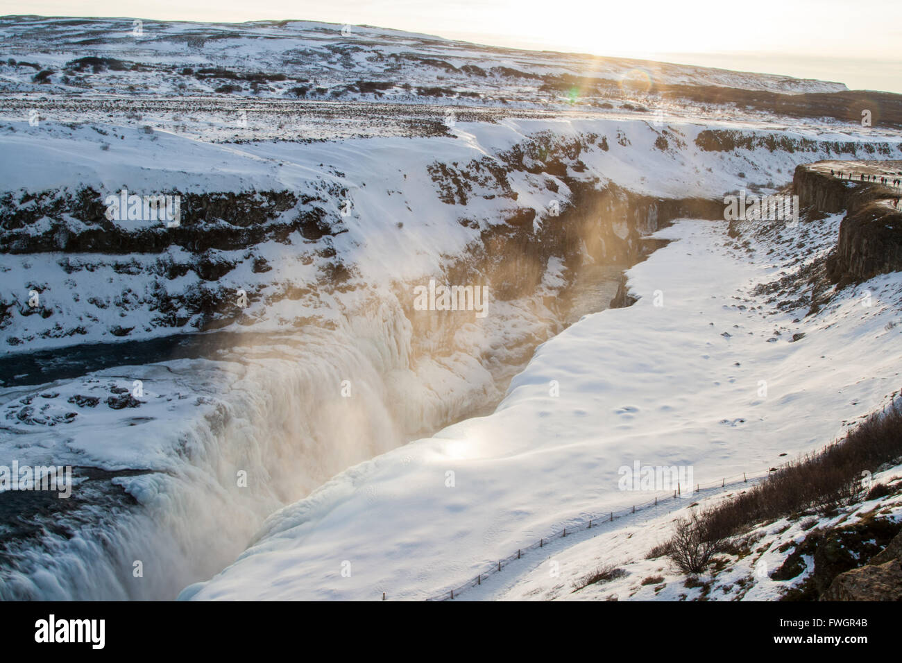 Light reflecting in spray above Gulfoss waterfalls in late afternoon in winter Stock Photo