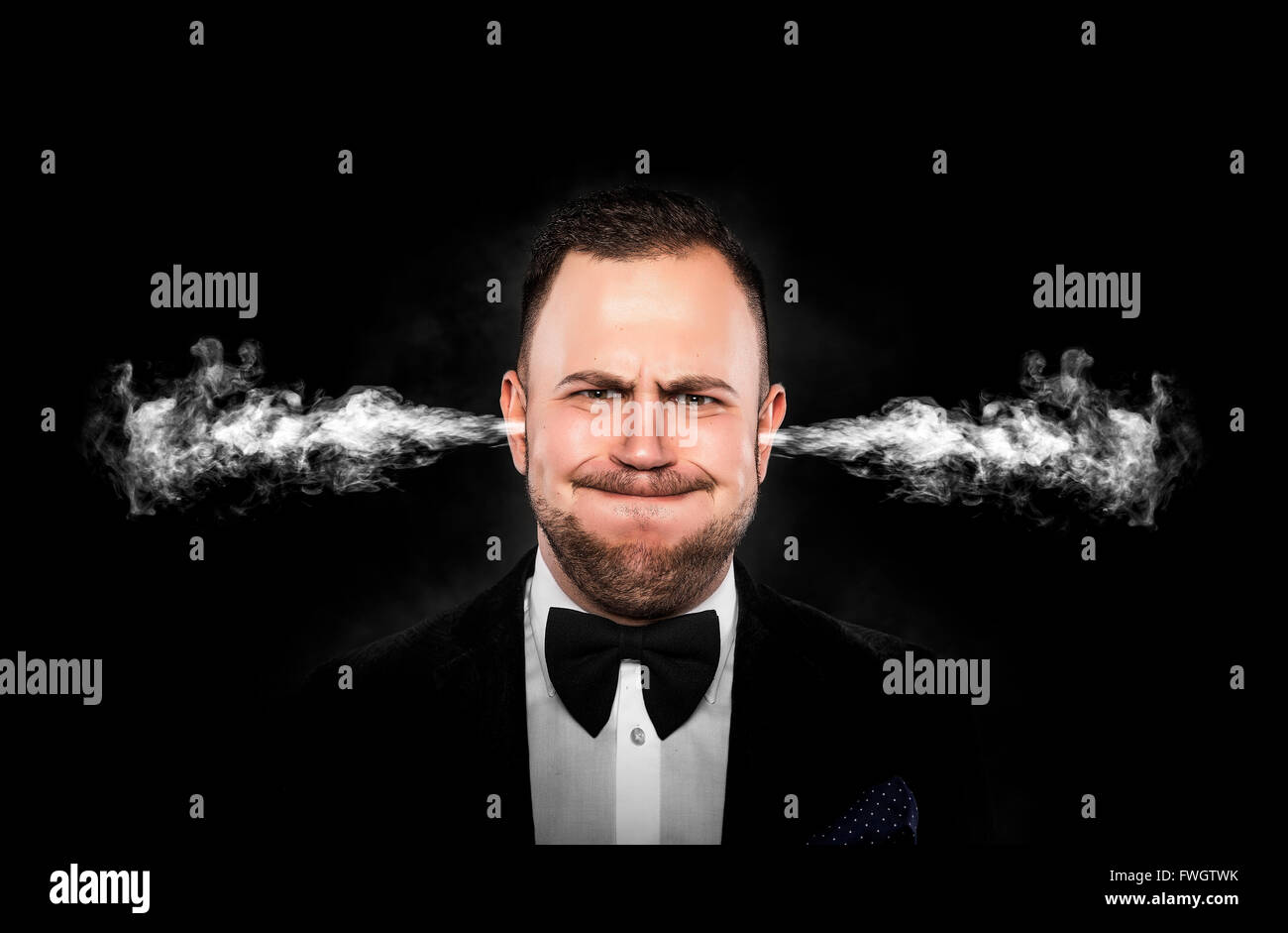 Stressful man with smoke or fume coming out from his ears on dark