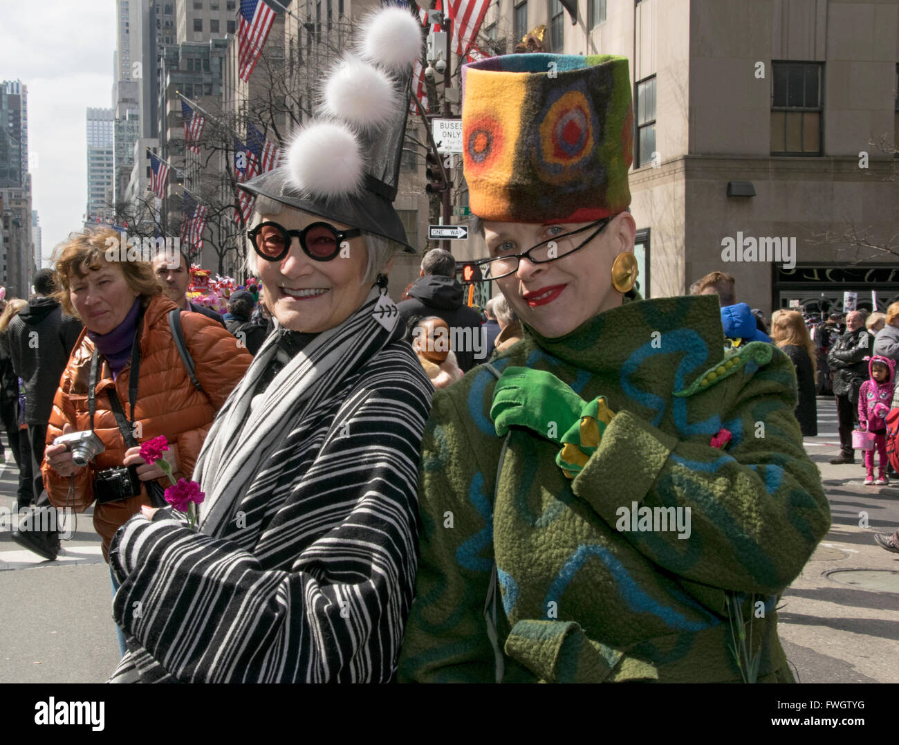 Two older women fashion bloggers in eccentric hats on Fifth avenue in Midtown Manhattan New York City, Stock Photo
