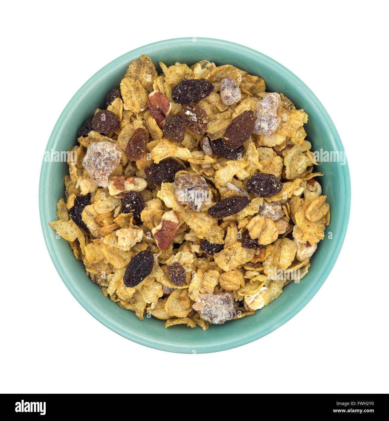 Top view of a bowl filled with pecans, raisins and dates breakfast cereal isolated on a white background. Stock Photo