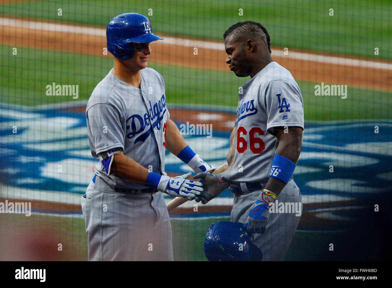 San Diego, CA, USA. 4th Apr, 2016. SAN DIEGO, CA, USA -- APRIL 4, 2016: .|.PADRES vs. DODGERS.Dodgers Yasiel Puig hits triple, then advances to score on a throwing error by Padres Cory Spangenberg. He is greeted by teammate Joc Pederson.|.Mandatory Credit: PHOTO BY NELVIN C. CEPEDA, SAN DIEGO UNION-TRIBUNE © Nelvin C. Cepeda/U-T San Diego/ZUMA Wire/Alamy Live News Stock Photo