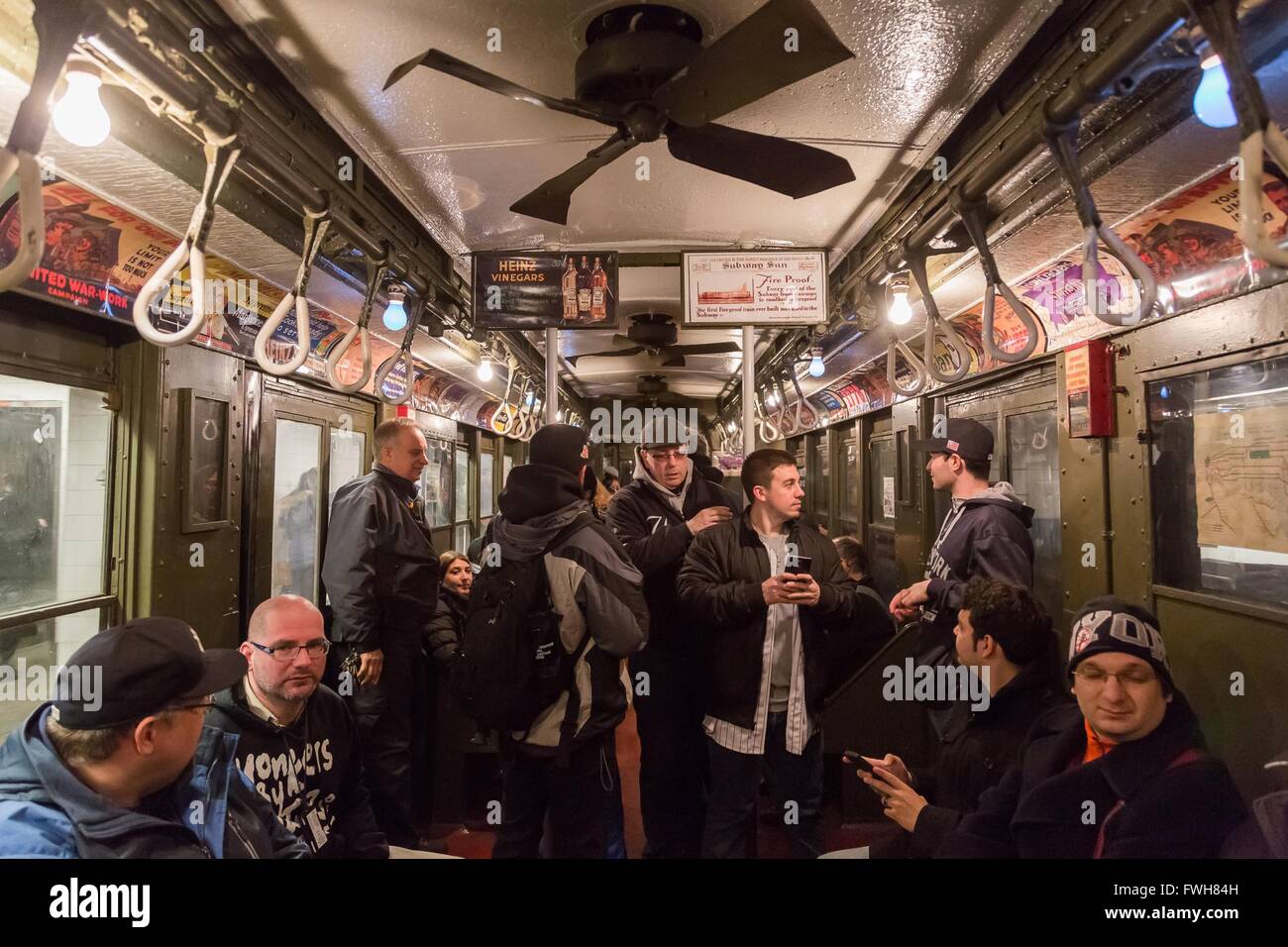 New York, USA. 5th Apr, 2016. Baseball fans ride the 'Nostalgia Special' train to Yankee Stadium in New York, the United States, April 5, 2016. The New York Metropolitan Transportation Authority rolls out a vintage train to take baseball fans to Yankee Stadium for the season's home opening game. Dubbed 'the Nostalgia Special', the antique train dates back to 1917, and was retired in the early 1960s. Credit:  Li Changxiang/Xinhua/Alamy Live News Stock Photo