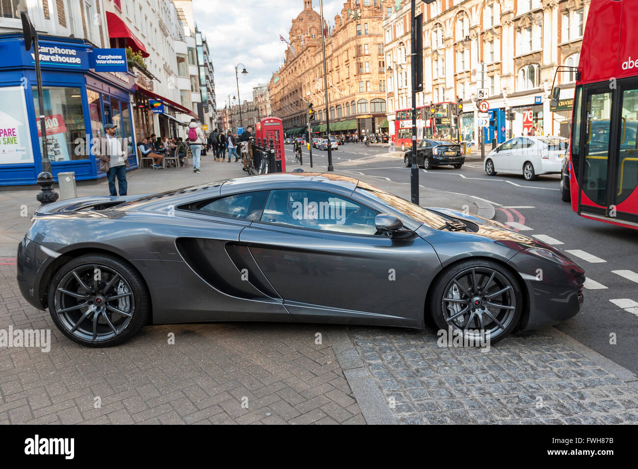 London, UK.  5 April 2016.  A McLaren MP4-12c with Monaco numberplates drives into traffic.  Supercars are in Knightsbridge as the 'season' for Middle Eastern owned supercars is about to commence. Credit:  Stephen Chung / Alamy Live News Stock Photo