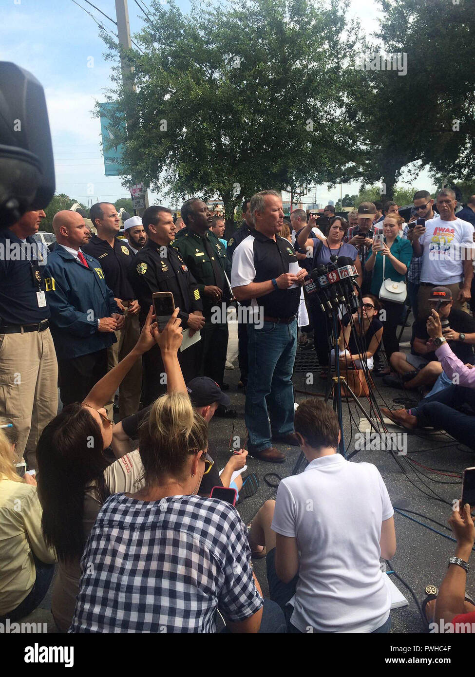 Orlando, USA. 12th June, 2016. Photo provided by Orlando Police Department shows Orlando Mayor Buddy Dyer (C) speaks to the media about the Pulse nightclub shooting in Orlando, Florida, the United States, June 12, 2016. About 50 people were killed and 53 others wounded early Sunday morning in a shooting incident at a gay nightclub in Orlando, Florida, according to Orlando mayor. © Orlando Police Department/Xinhua/Alamy Live News Stock Photo