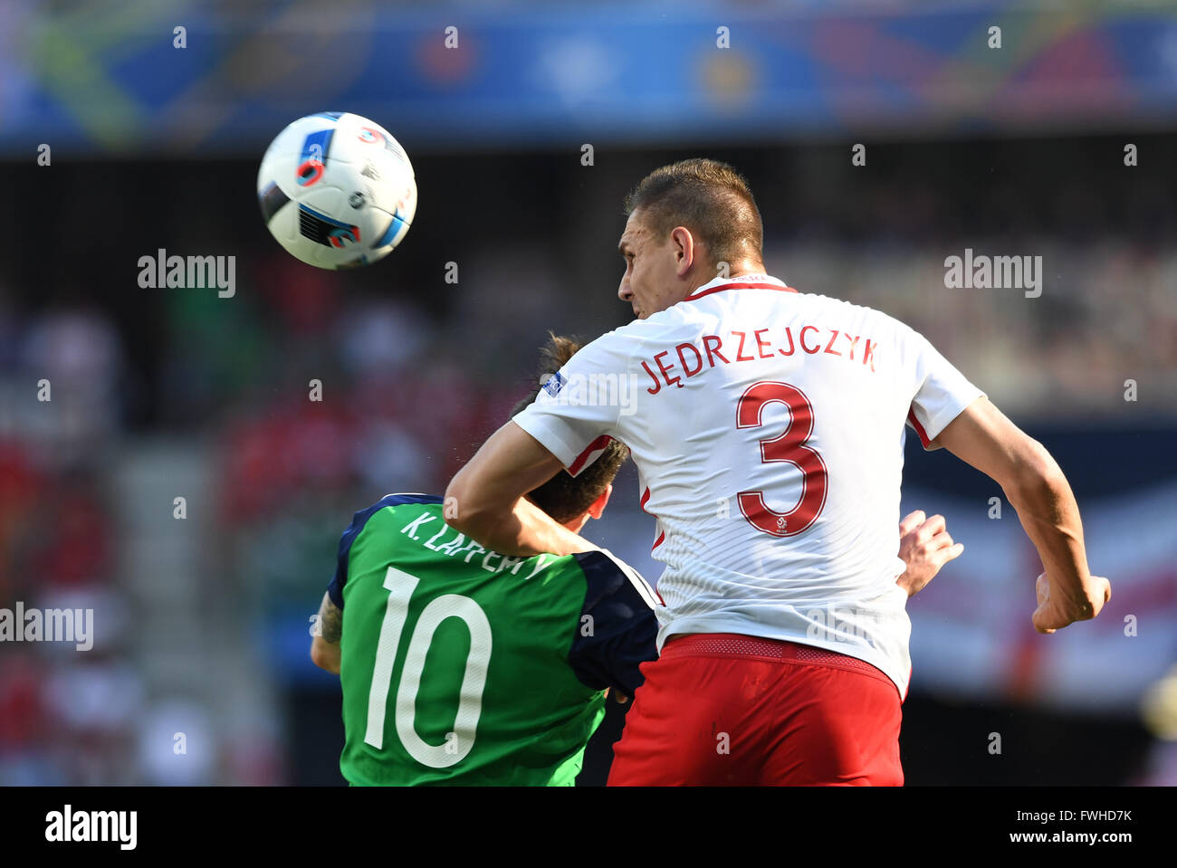 Artur Jedrzejczyk (R) of Poland and Kyle Lafferty of Northern Ireland challenge for the ball during the UEFA Euro 2016 Group C soccer match between Poland and Northern Ireland in Nice, France, June 12, 2016. Photo: Federico Gambarini/dpa Stock Photo