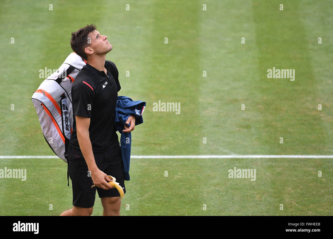 Dominic Thiem of Austria looks up to the sky as he walks off the pitch during a rain break in his final match against Philipp Kohlschreiber of Germany at the ATP tennis tournament in Stuttgart, Germany, 12 June 2016. Photo: MARIJAN MURAT/dpa Stock Photo