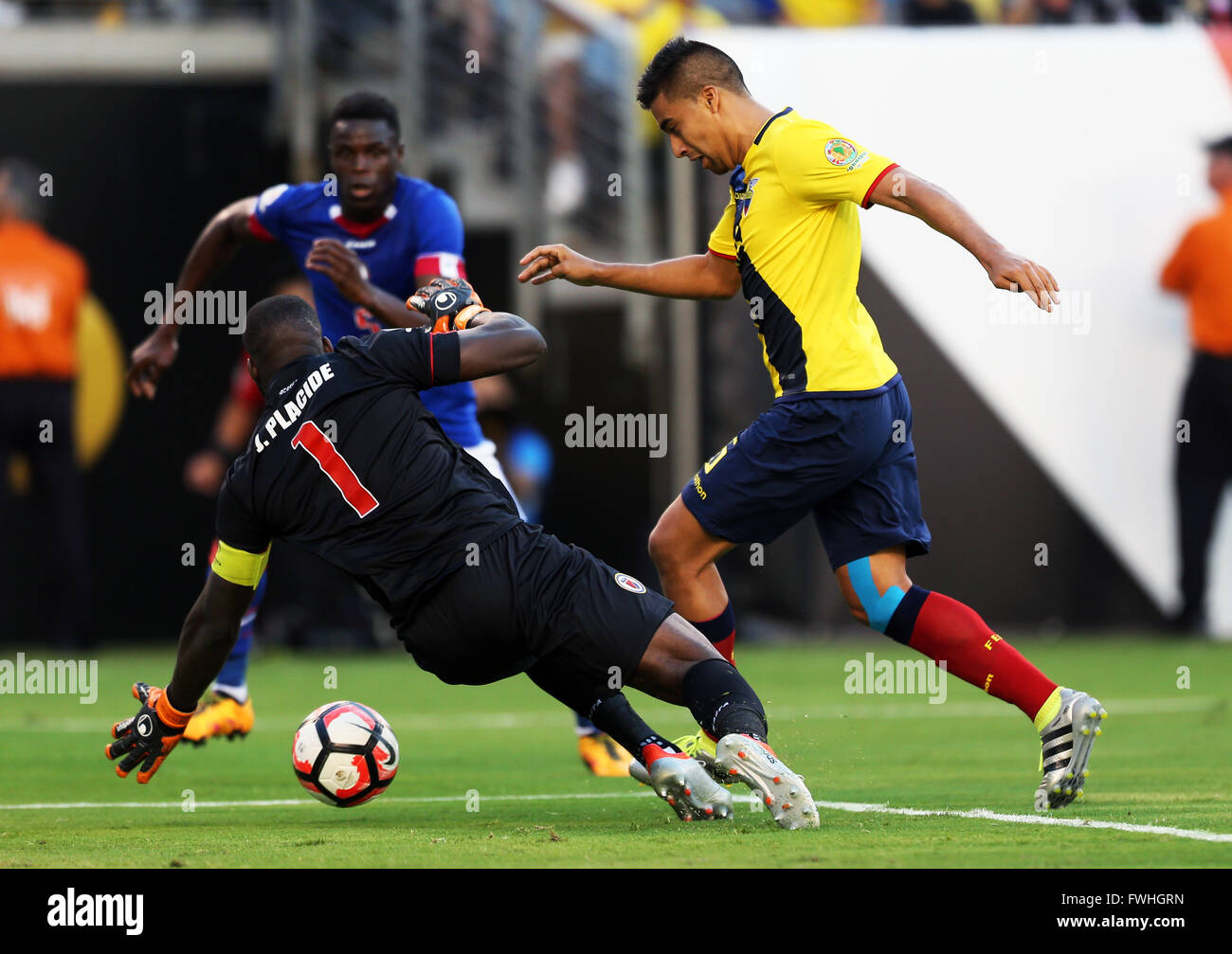 New Jersey, USA. 12th June, 2016. Haiti's goalkeeper Johnny Placide (L) attempts to block Ecuador's Christian Noboa during their Copa America Centenario football tournament match in East Rutherford, New Jersey, United States, on June 12, 2016. Ecuador won 4-0. Credit:  Qin Lang/Xinhua/Alamy Live News Stock Photo