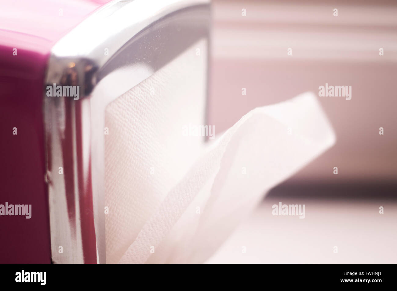 Paper napkins dispenser in restaurant cafe on table photo Stock Photo