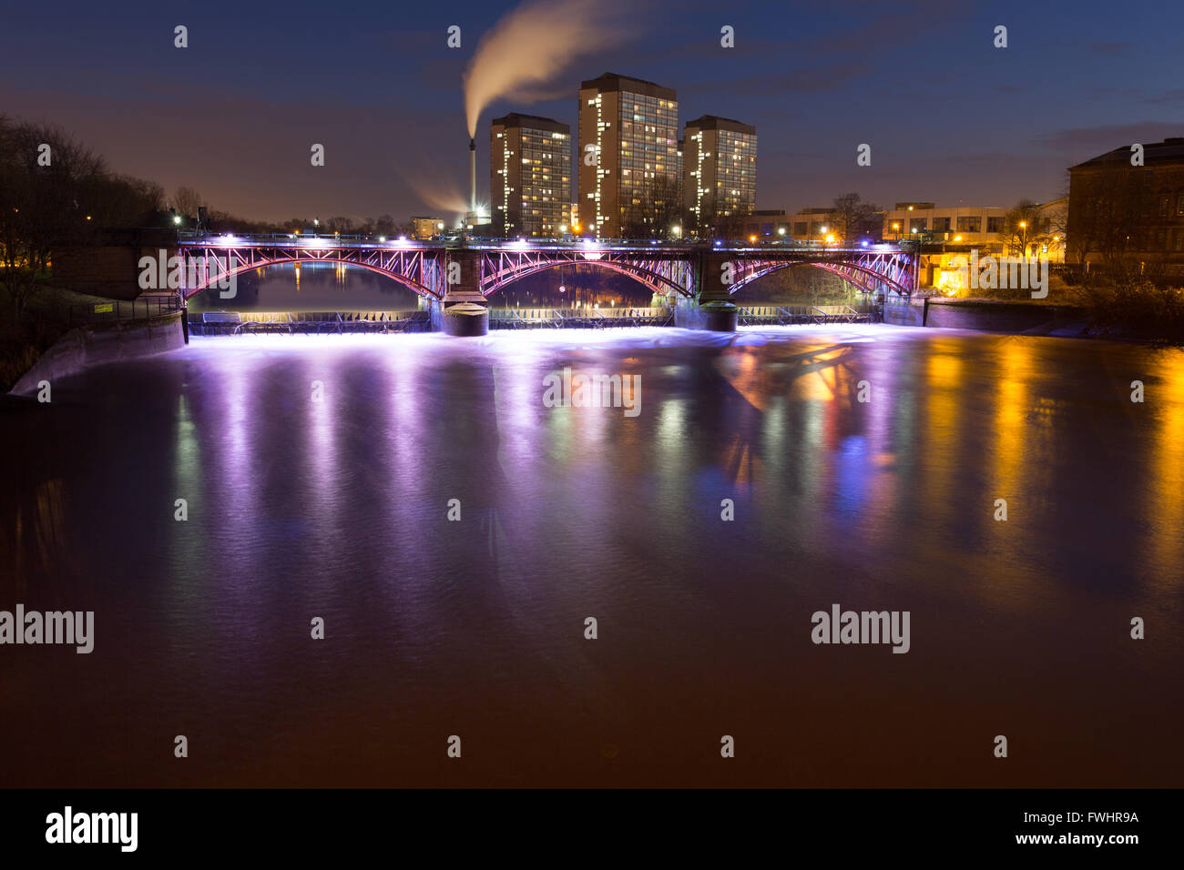 City of Glasgow, Scotland. Picturesque night view of the weir and pipe bridge over the River Clyde. Stock Photo