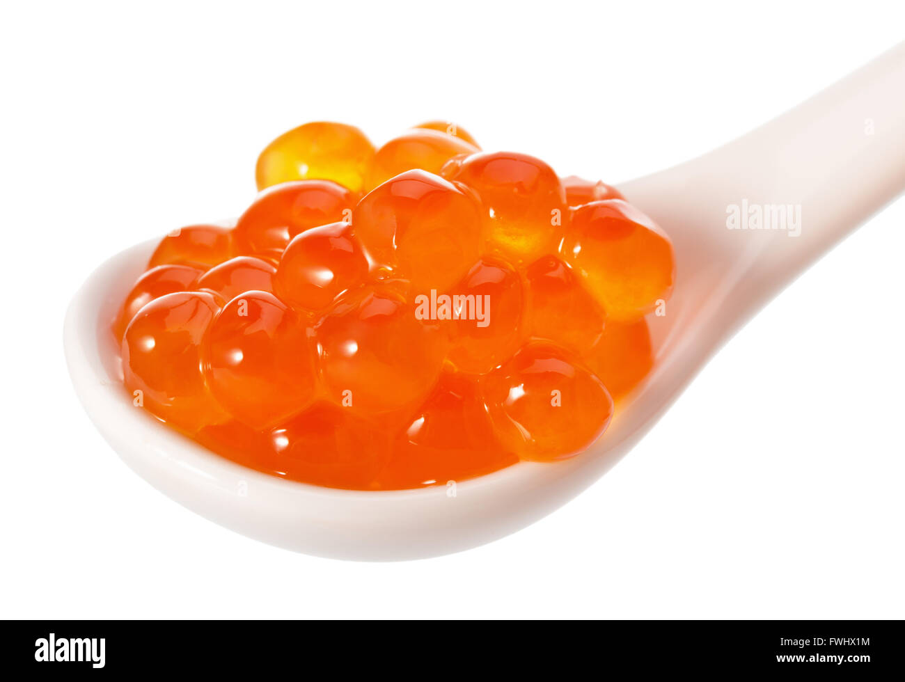 red caviar in white spoon isolated on the white background. Stock Photo