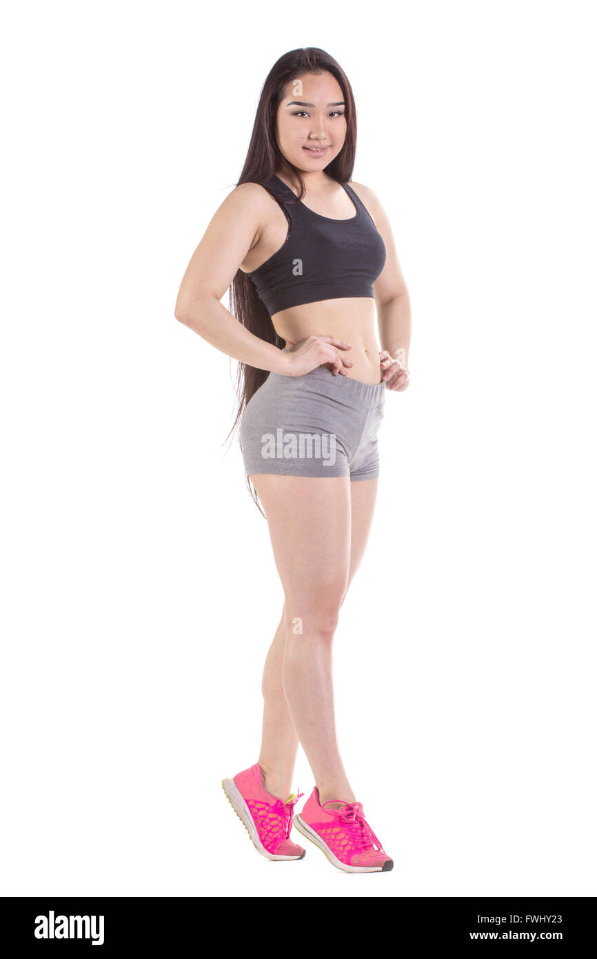 Beautiful fitness oriental woman standing - isolated over a white background Stock Photo