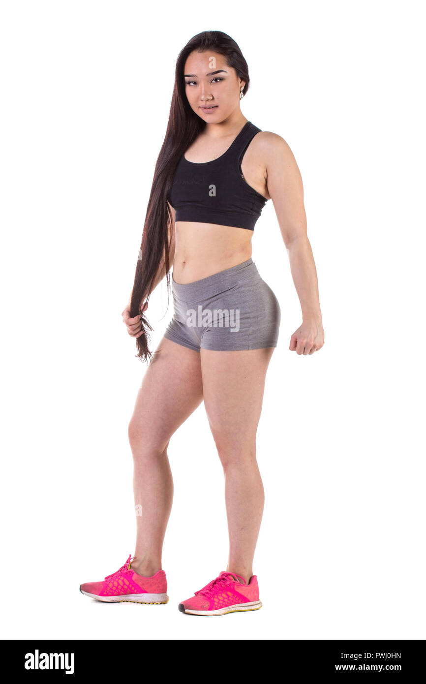 Beautiful fitness oriental woman standing - isolated over a white background Stock Photo