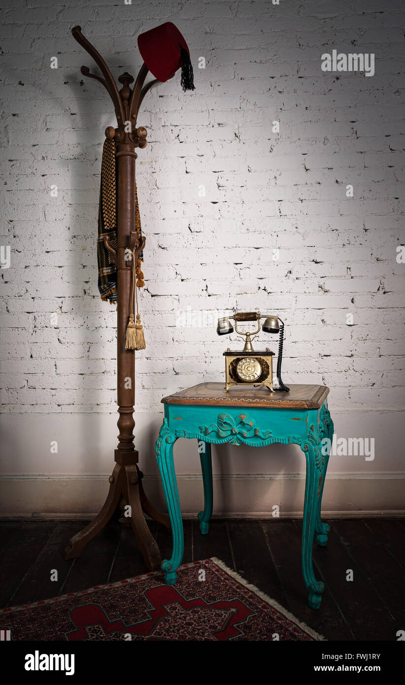 Green vintage table, old telephone set, and coat hanger Stock Photo