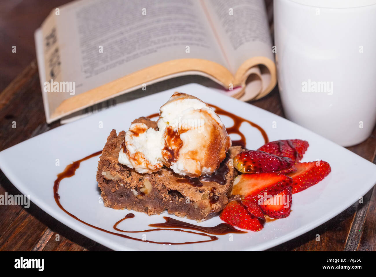Brownie With Ice Cream And Strawberry, Relaxing Reading Evening Stock Photo Alamy