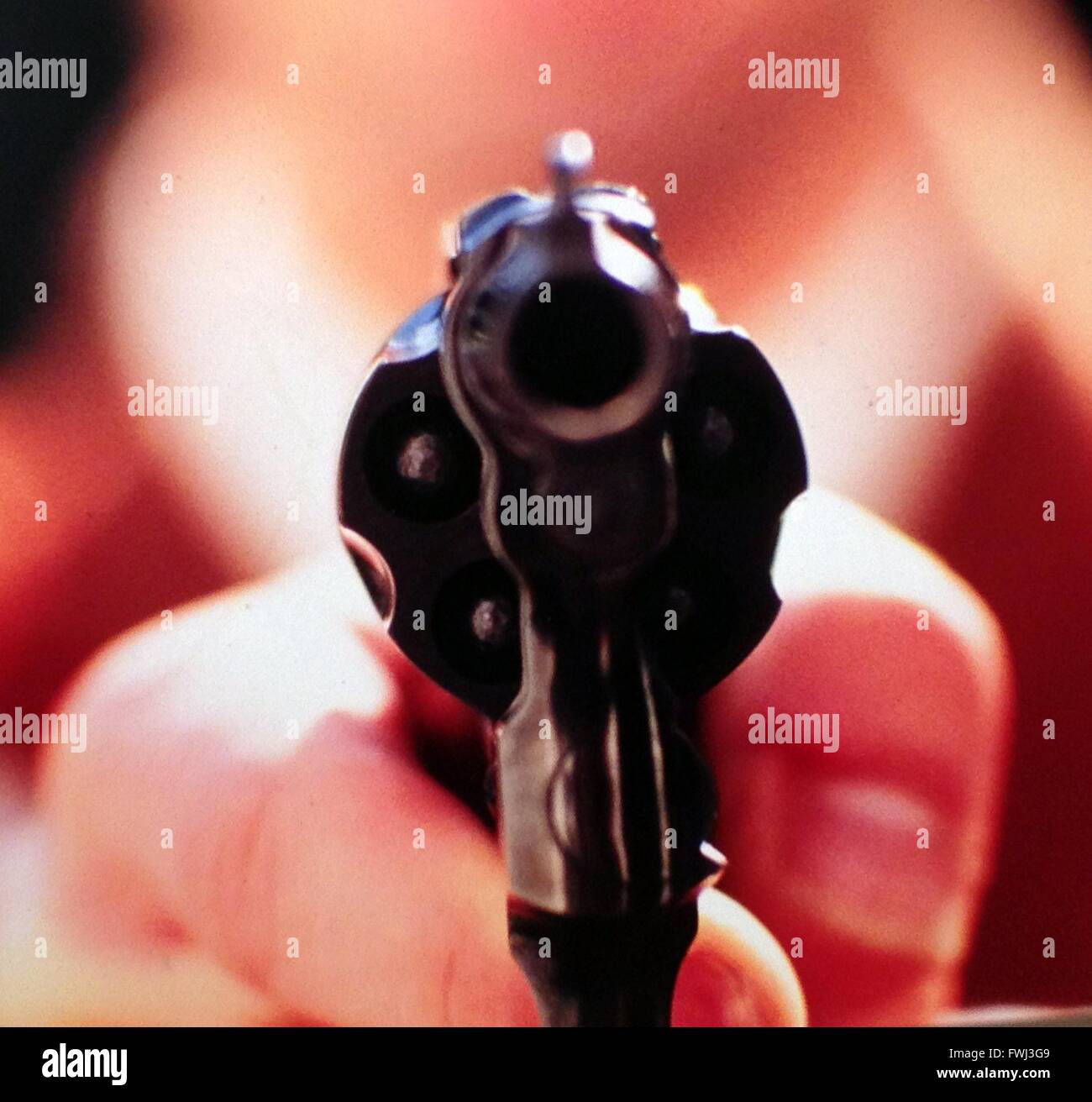 Close-Up Of Blurred Hand Holding Gun Stock Photo