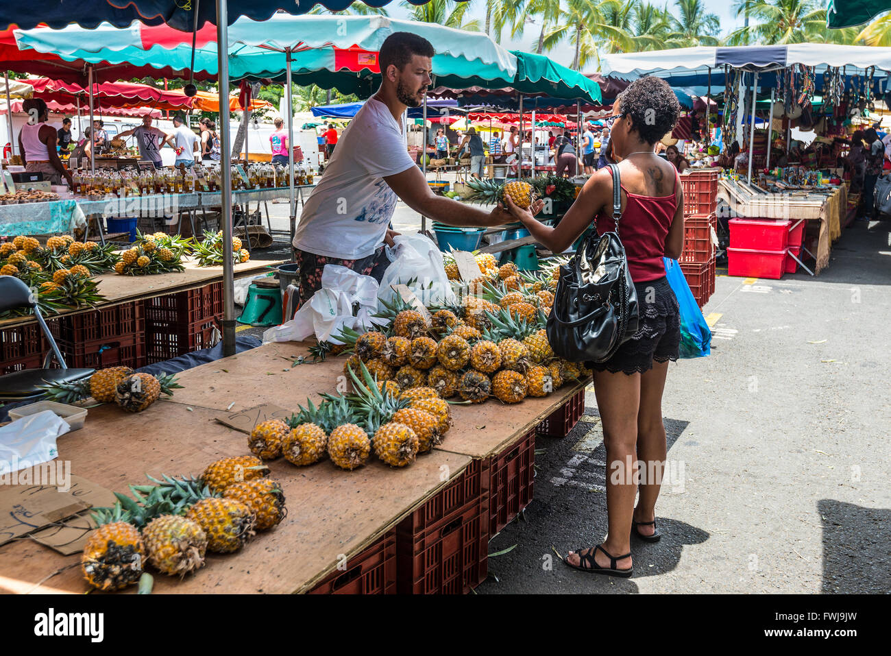 Vendor fresh fruit pineapple on a local market in Saint Paul on the island of La Reunion (France) Stock Photo
