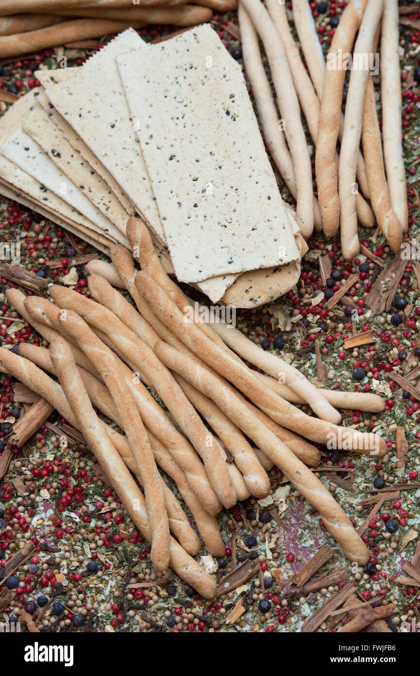 Italian Crispy flatbread / Croccante and Sesame rubato breadsticks on a dried herb and spice background Stock Photo