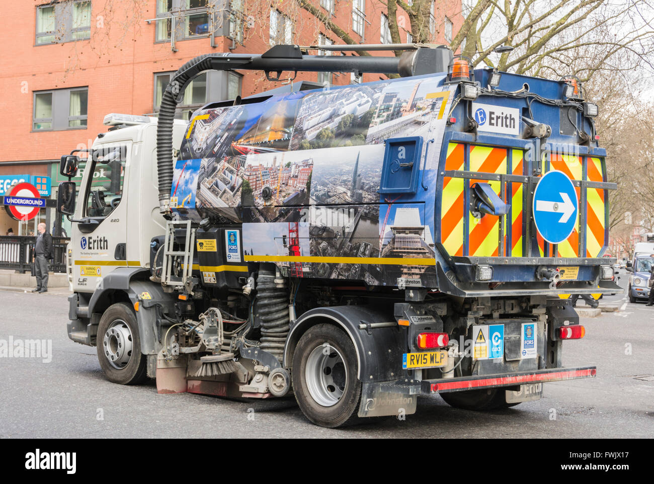 Mechanical road sweeper working on a road in central London Stock Photo