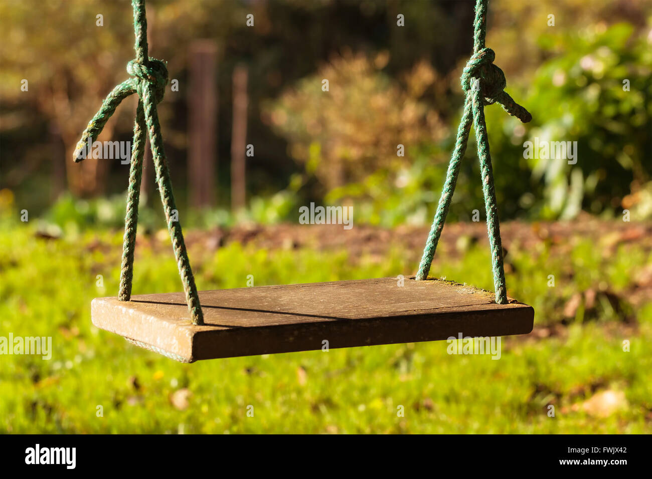 Swing Is A Hanging Seat, Often Found At Playgrounds For Children Stock Photo