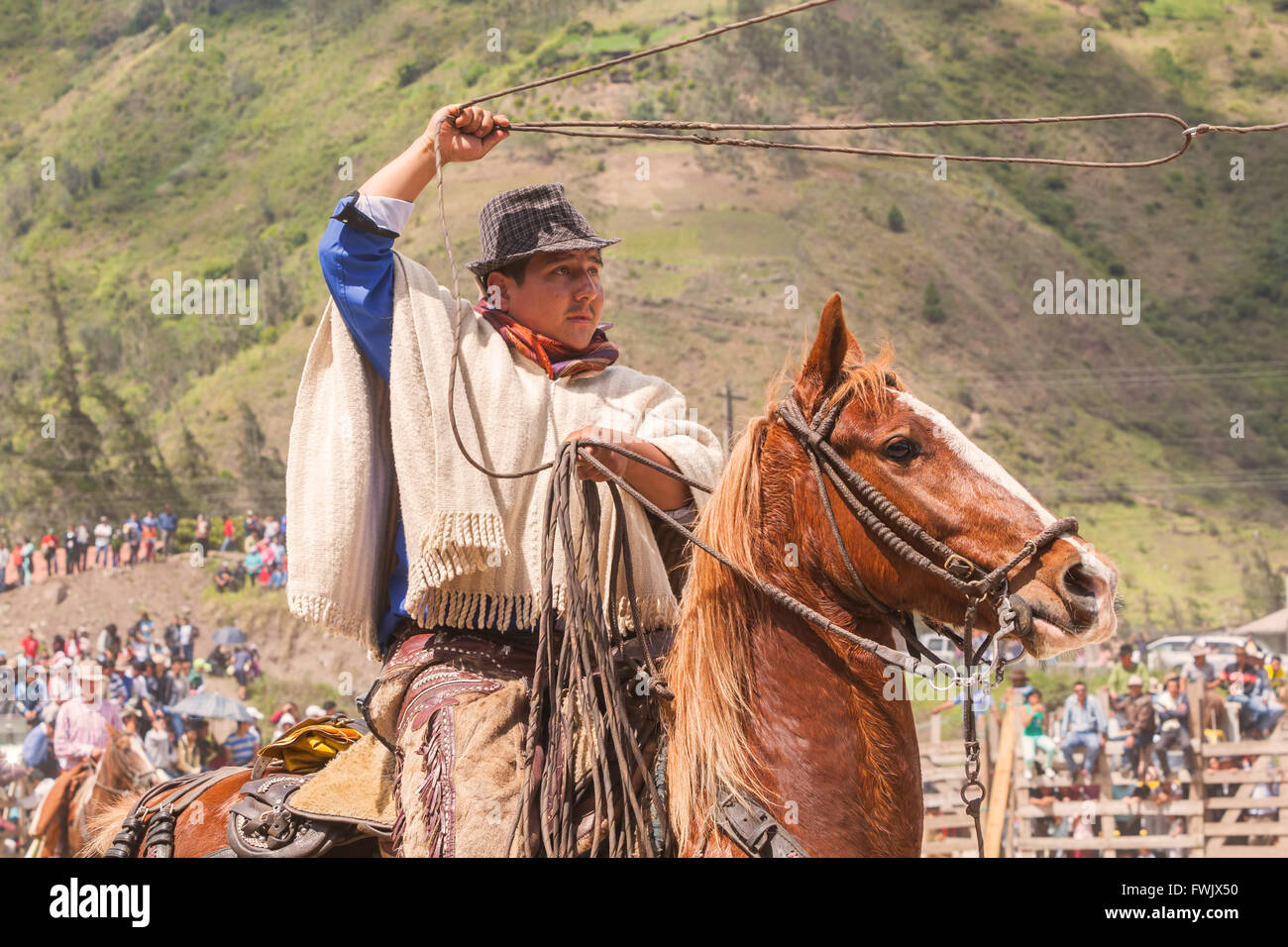 Banos, Ecuador - 30 November 2014: Latin Indigenous Cowboy Riding A Horse And Throws A Lasso, South America In Banos Stock Photo