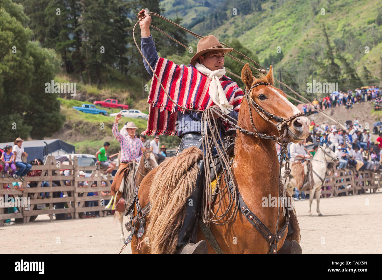 Banos, Ecuador - 30 November 2014: Indigenous Cowboy Riding Horse And Swinging Lasso, South America In Banos Stock Photo