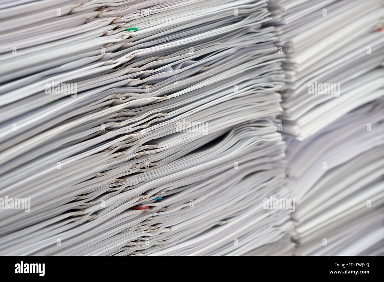 Pile of documents on desk stack up high Stock Photo