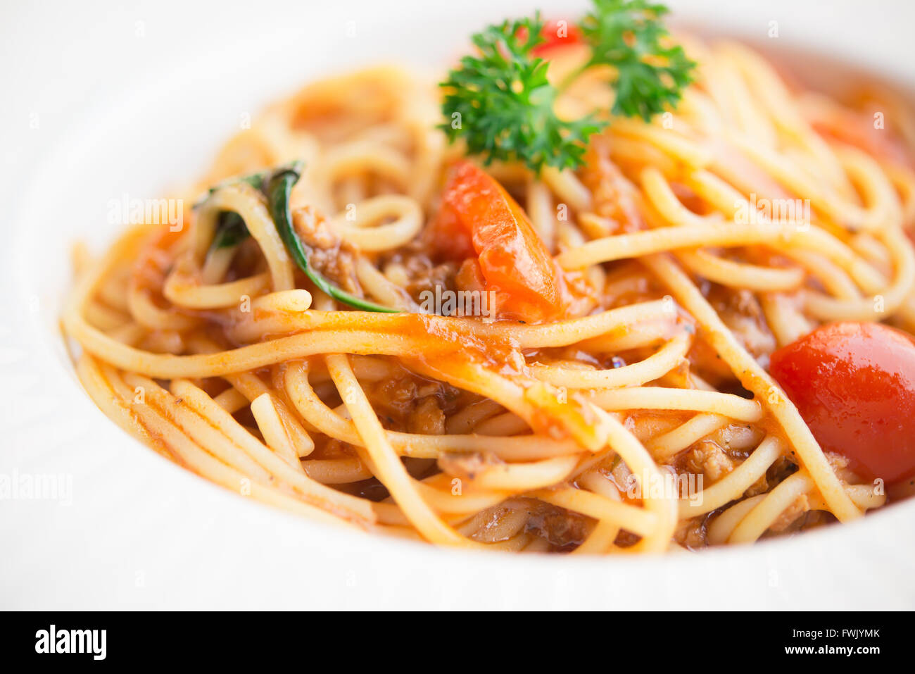 Healthy plate of Italian spaghetti topped with a tasty tomato and ground beef Stock Photo