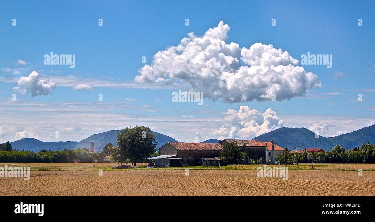 House By Field Against Sky Stock Photo